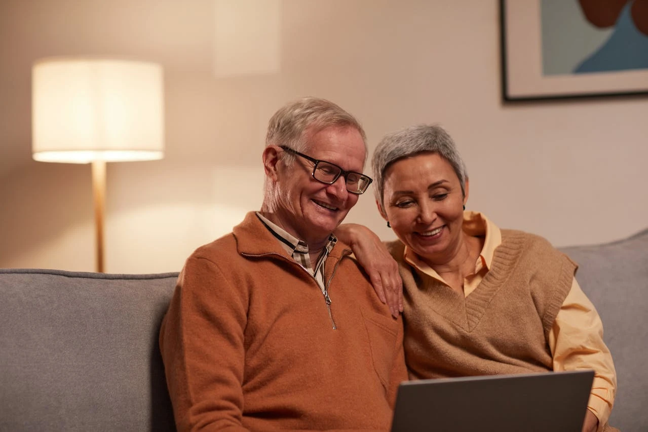 A family reviewing their monthly budget on a tablet, with a pie chart showing expense categories.